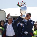 portugal team getting off plane with euro 2016 trophy. ronaldo and santos