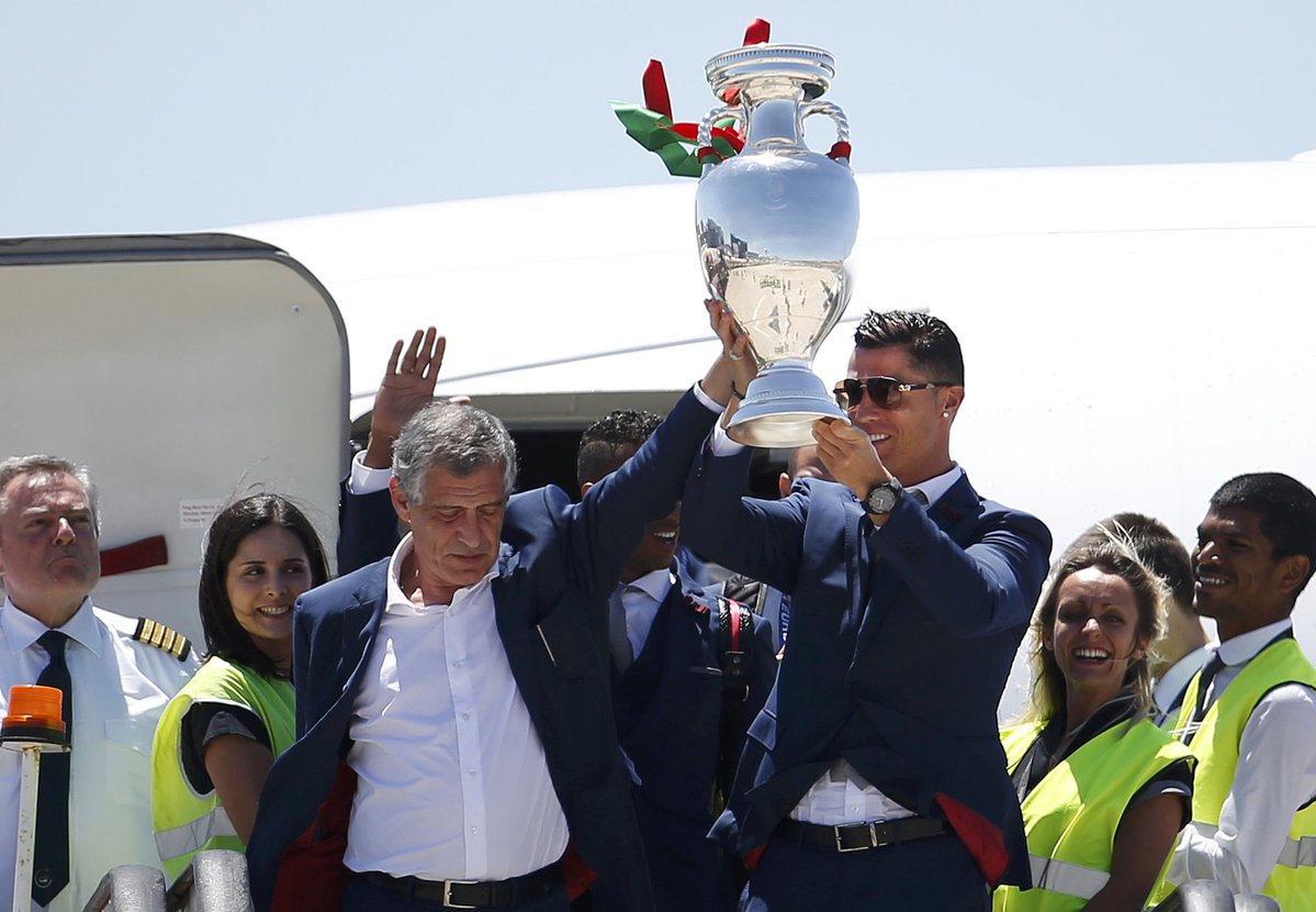 portugal team getting off plane with euro 2016 trophy. ronaldo and santos