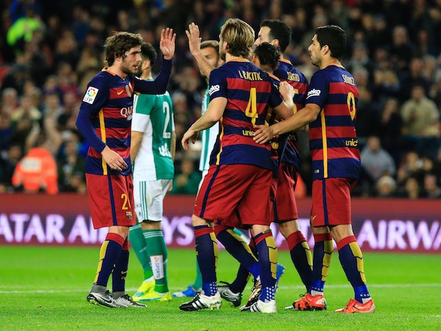 Barcelona players celebrate after an own goal of Real Betis' German defender Heiko Westermann during the Spanish league football match FC Barcelona vs Real Betis Balompie at the Camp Nou stadium in Barcelona on December 30, 2015. AFP PHOTO/ PAU BARRENA / AFP / PAU BARRENA (Photo credit should read PAU BARRENA/AFP/Getty Images)