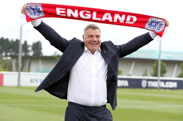 Happier Days: Sam Allardyce holds aloft the Three Lions scarf at St. George's Park.