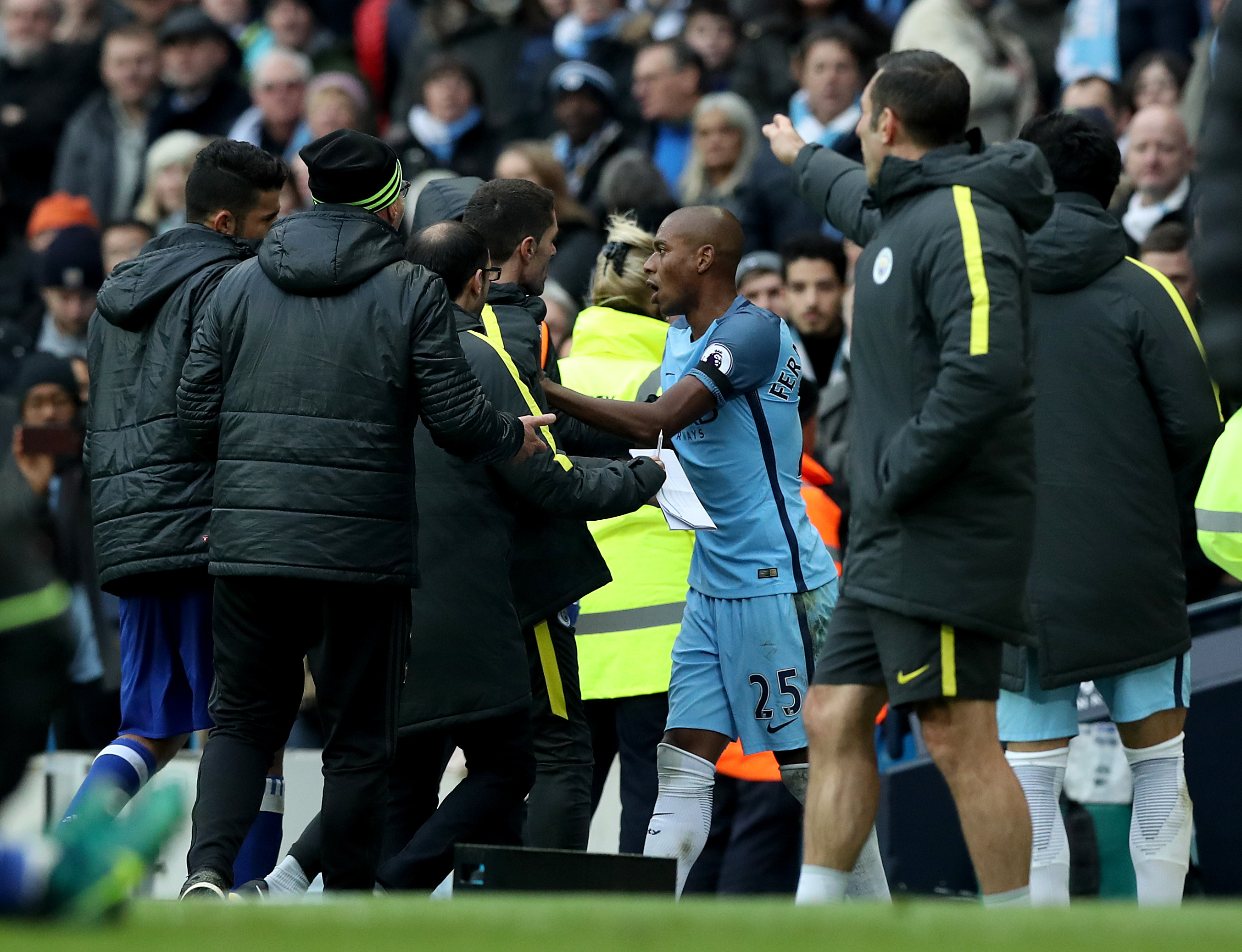 Manchester City's Fernandinho (centre) has some words as he is sent-off during the Premier League match at the Etihad Stadium, Manchester.