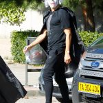 EXCLUSIVE: A costumed Cristiano Ronaldo picks up his son ina Madrid Spain