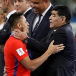 Alexis Sanchez is comforted by Argentinian legend Diego Maradona after Chile lost in the final