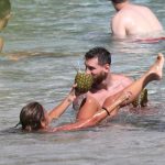Antonella Roccuzzo held out a hollowed out pineapple for her husband to sip from