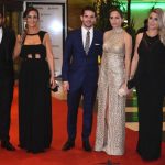 Paris Saint Germain’s footballer Angel di Maria (R), Boca Juniors’ footballer Fernando Gago (C) and Sevilla’s footballer Ever Banegas pose with their wives.