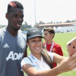 Pogba poses with a fan after training