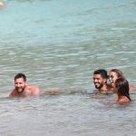 The close friends laughed in the sea as they relaxed in the sunThe close friends laughed in the sea as they relaxed in the sun