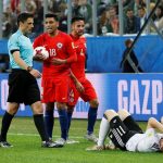 Timo Werner lays on the ground after being elbowed in the face by Chile man Gonzalo Jara