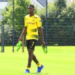 Dembele walks towards his seat as his Dortmund team-mates