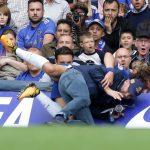 David Luiz takes a fall as he collides with a cameraman on the side of the pitch