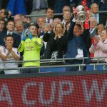 Van Gaal lifts the trophy as his players applaud