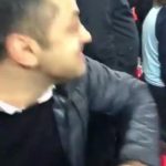 The Spurs fan launches the cup at rival West Ham supporters