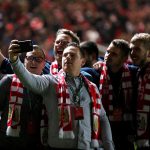 Bristol City fans storm the pitch in celebration after their historic win