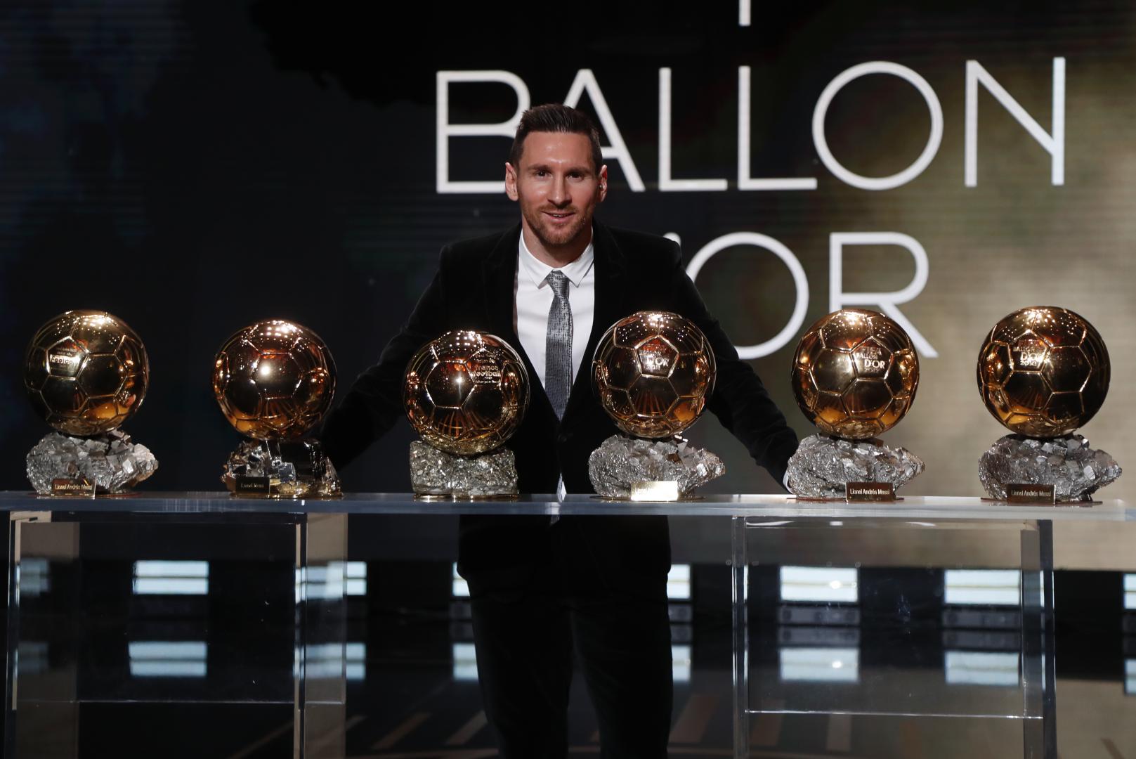Lionel Messi poses with his six Ballon d'Or trophies